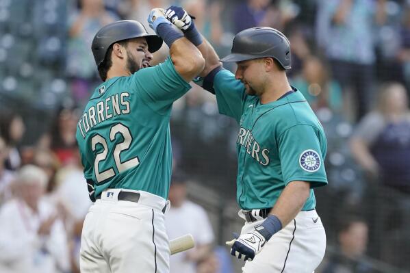 Seattle Mariners' Cal Raleigh, right, is greed by Luis Torrens (22) after Raleigh hit a two-run home run against the Oakland Athletics during the second inning of a baseball game, Friday, July 23, 2021, in Seattle. Torrens hit a solo home run in his ensuing at-bat. (AP Photo/Ted S. Warren)