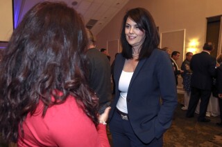 FILE -Incumbent Delaware County District Attorney Katayoun Copeland chats with supporter Lisa Savage from Media at GOP Headquarters in Springfield, Pa., Tuesday, Nov. 5, 2019. Former federal prosecutor Katayoun “Kat” Copeland will run for attorney general of Pennsylvania in 2024's election, she said this week, Friday, Nov. 24, 2023. (Steven M. Falk/The Philadelphia Inquirer via AP, File)