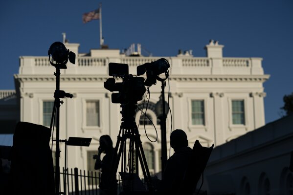 FILE - In this Nov. 4, 2020, file photo journalists gather outside the White House in Washington. A new study of people's attitudes toward the press finds that distrust goes deeper than just partisanship and down to how journalists define their mission. Americans want their journalists to be more than watchdogs. (AP Photo/Evan Vucci, File)