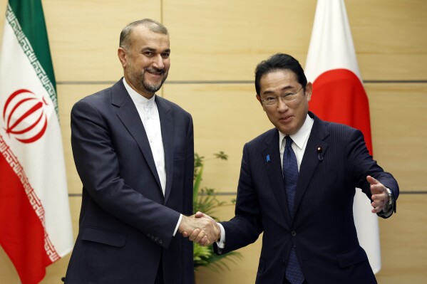 Iranian Foreign Minister Hossein Amir-Abdollahian, left, meets with Japanese Prime Minister Fumio Kishida at Kishida's office in Tokyo Monday, Aug. 7, 2023. (Issei Kato/Pool Photo via AP)