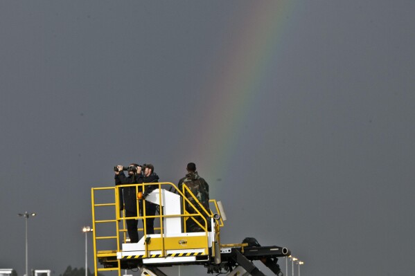 Secret service agents watch through their binoculars as a rainbow appears in the sky before President Barack Obama arrived at Bole International Airport in Addis Ababa, Ethiopia, on July 26, 2015. Members of Ethiopia’s LGBTQ+ community say they face a wave of online harassment and physical attacks and blame much of it on the social media platform TikTok, which they say is failing to take down posts calling for homosexual and transgender people to be whipped, stabbed and killed. (AP Photo/Sayyid Azim)