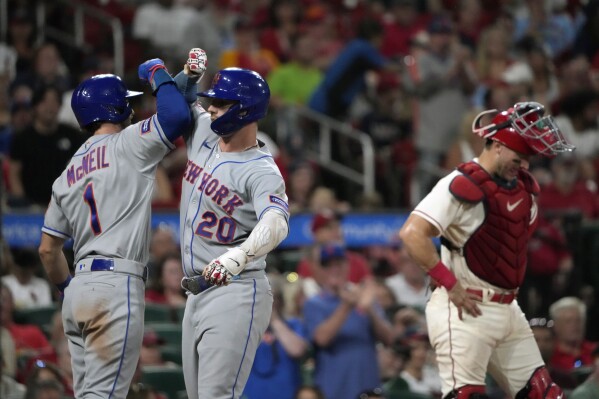 New York Mets Pete Alonso (20) congratulates New York Mets Francisco Lindor  (12) on his home run against the Chicago Cubs during the first inning of a  baseball game Wednesday, April 21