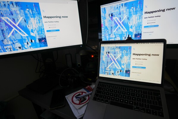 FILE - Computer monitors and a laptop display the X, formerly known as Twitter, sign-in page, July 24, 2023, in Belgrade, Serbia. The U.S. government says the former Twitter's request to end oversight of its data privacy and security practices is “meritless” and owner Elon Musk should not be immune to testifying about the company since he has “first-hand knowledge” of the conduct being investigated. (AP Photo/Darko Vojinovic, File)