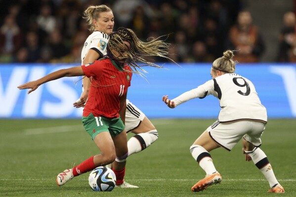 Morocco's Fatima Tagnaout vies for the ball with Germany's Svenja Huth, right, during the Women's World Cup Group H soccer match between Germany and Morocco in Melbourne, Australia, Monday, July 24, 2023. (AP Photo/Hamish Blair)