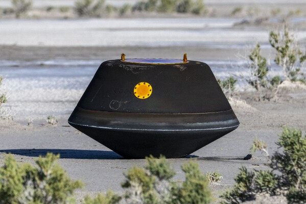 In this photo provided by NASA, the sample return capsule from NASA's Osiris-Rex mission lies on the ground shortly after touching down in the desert, at the Department of Defense's Utah Test and Training Range on Sept. 24, 2023. (Keegan Barber/NASA via AP, file)