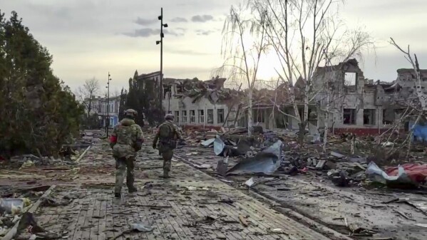 In this photo taken from video distributed by the Russian Defense Ministry Press Service on Thursday, March 13, 2025, Russian soldiers patrol an area in Sudzha, in the Kursk region of Russia, after it was taken over by Russian troops. (Russian Defense Ministry Press Service via AP)