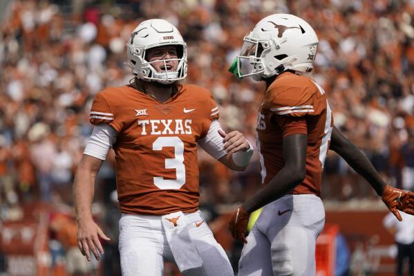 Texas quarterback Quinn Ewers (3) and wide receiver Xavier Worthy (8) celebrate after they connected on a touchdown pass against Iowa State during the second half of an NCAA college football game, Saturday, Oct. 15, 2022, in Austin, Texas. (AP Photo/Eric Gay)