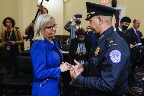 FILE - In this July 27, 2021 file photo, Rep. Liz Cheney, R-Wyo., speaks with U.S. Capitol Police Sgt. Aquilino Gonell after a House select committee hearing on the Jan. 6 attack on Capitol Hill in Washington. House Democrats have promoted Republican Rep. Liz Cheney to vice chairwoman of a committee investigating the Jan. 6 Capitol insurrection. They're placing Cheney in a leadership spot on the panel as some members of the GOP caucus are threatening to oust her for participating. Cheney is a fierce critic of former President Donald Trump and has remained defiant amid the criticism from her own party. (Jim Bourg/Pool via AP)