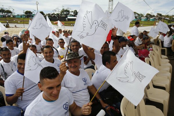 
              Rebels of the Revolutionary Armed Forces of Colombia, FARC, wave white peace flags during an act to commemorate the completion of their disarmament process in Buenavista, Colombia, Tuesday, June, 27, 2017. The United Nations says it has concluded the disarmament process for individual arms as part of a peace deal between Colombia's FARC rebels and the government. (AP Photo/Fernando Vergara)
            