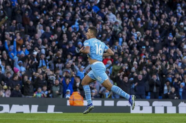 Manchester City's Rodrigo, left, celebrates after scoring his team second goal during the English Premier League soccer match between Manchester City and Everton at Etihad stadium in Manchester, England, Sunday, Nov. 21, 2021. (AP Photo/Jon Super)