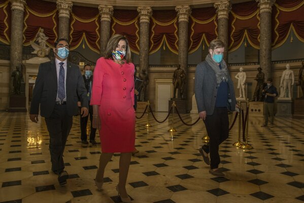 House Speaker Nancy Pelosi walks towards the House Chamber at the Capitol, Monday, July 20, 2020, in Washington. Pelosi, who presided over a moment of silence for Georgia Rep. John Lewis, choked up Monday recalling their last conversation the day before he died.  “It was a sad one,” Pelosi said of their conversation Thursday. “We never talked about his dying until that day.”  Lewis, 80, died Friday, several months after he was diagnosed with advanced pancreatic cancer.  (AP Photo/Manuel Balce Ceneta)