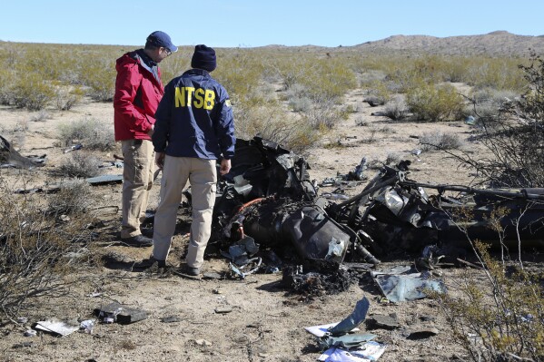 NTSB investigators survey the site of an Airbus Helicopters EC-130 on Sunday, Feb. 11, 2024, near Halloran Springs, Calif. The crash in the Mojave Desert killed, Herbert Wigwe, CEO of one of Nigeria's largest banks along with his wife and son. (Peter Knudson/NTSB via AP)