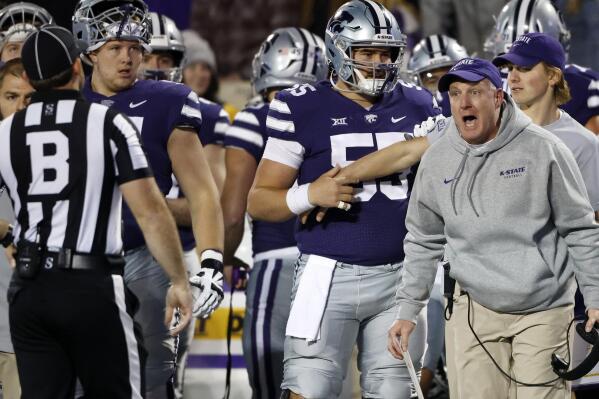 Kansas State head coach Chris Klieman, right, yells at an official after his team was flagged for interfering on a fair catch on a punt during the first half of an NCAA college football game against Baylor on Saturday, Nov. 20, 2021 in Manhattan, Kan. (AP Photo/Colin E. Braley)