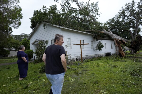 FILE - Ann McCauley, right, examines the damage at Bethel Church after Hurricane Beryl moved through the area July 8, 2024, in Van Vleck, Texas. (ĢӰԺ Photo/Eric Gay, File)