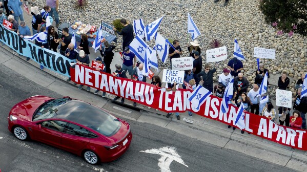 Protesters rally outside Tesla's Fremont, Calif., factory as Israeli Prime Minister Benjamin Netanyahu plans a visit with businessman Elon Musk on Monday, Sept. 18, 2023. (AP Photo/Noah Berger)