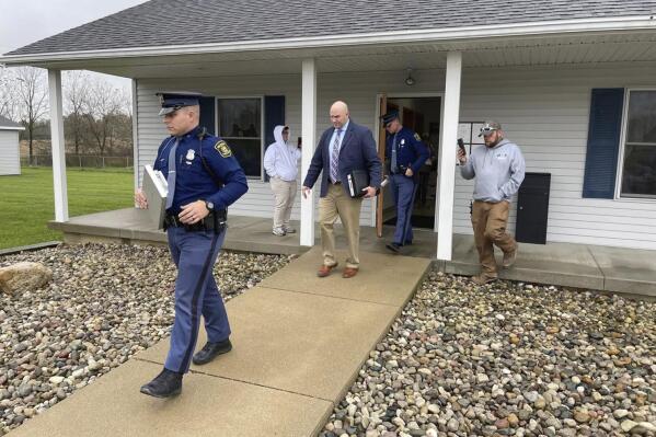 FILE - The Michigan State Police exit the Adams Township Hall after executing a search warrant, Oct. 29, 2021 in Hillsdale, Mich. The search warrant was part of an investigation into actions by Clerk Stephanie Scott who has been stripped of her role in future elections. Voters in one of Michigan's most conservative counties on Tuesday, May 3, 2023, ousted Scott accused of improperly handling voting equipment after casting doubt on President Joe Biden’s election victory. (Corey Murray/Hillsdale Daily News via AP, File)