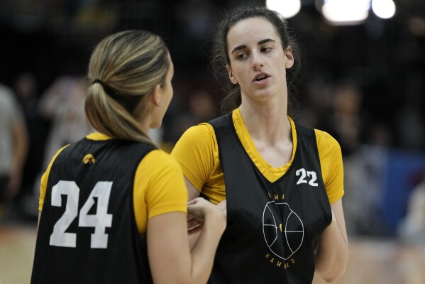 Iowa's Caitlin Clark talks to Gabbie Marshall during practice for the NCAA Women's Final Four championship basketball game Saturday, April 6, 2024, in Cleveland. (AP Photo/Morry Gash)