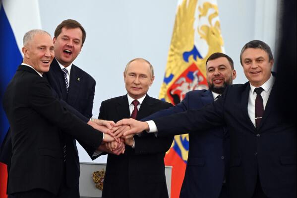 From left, Vladimir Saldo, the head of the Kherson region; Yevgeny Balitsky, the head of the Zaporizhzhia region; Russian President Vladimir Putin, center; Denis Pushilin, head of the self-proclaimed Donetsk People's Republic; and Leonid Pasechnik, head of the self-proclaimed Luhansk People's Republic, pose at a ceremony to sign treaties to illegally annex Ukrainian territories at the Kremlin in Moscow, on Friday, Sept. 30, 2022, in a sharp escalation of the war in Ukraine. Putin sent troops into Ukraine on Feb. 24, 2022, and appears determined to prevail. (Grigory Sysoyev, Sputnik, Kremlin Pool Photo via AP, File)