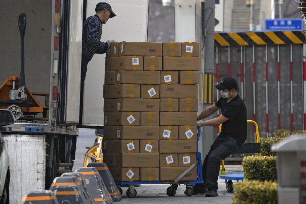 FILE - Workers offload boxes containing frozen beef from a truck for a restaurant at a shopping mall in Beijing on Feb. 27, 2023. As incomes in China have risen in the last decade, beef, once a luxury, is now popular on middle-class menus. (AP Photo/Andy Wong, File)