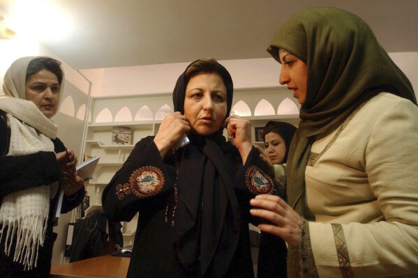 FILE - Iranian Nobel peace laureate Shirin Ebadi, center, adjusts her scarf, as she speaks with fellow activists Narges Mohammadi, right, while Marzieh Mortazi looks on, prior to her press conference at the Center for Protecting Human Rights in Tehran, Iran, Monday, Jan. 17, 2005. The Nobel Peace Prize has been awarded to Narges Mohammadi for fighting oppression of women in Iran. The chair of the Norwegian Nobel Committee announced the prize Friday, Oct. 6, 2023 in Oslo. (AP Photo/Vahid Salemi, File)