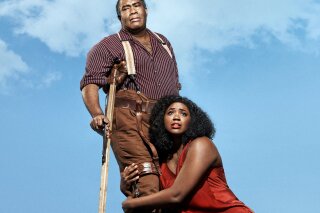 This undated image released by the Metropolitan Opera shows Eric Owens as Porgy, left, and Angel Blue as Bess in the Gershwins' "Porgy and Bess." The Metropolitan Opera will hire an all-black outside chorus next season for its first presentation in nearly three decades of the Gershwins' "Porgy and Bess," which opens the season on Sept. 23. (Paola Kudacki/Metropolitan Opera via AP)