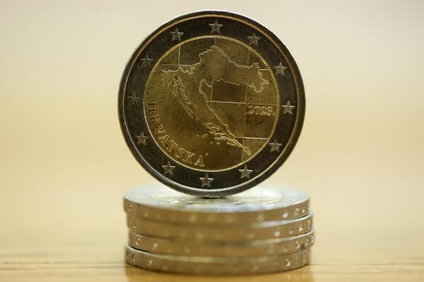 New Croatian euro coin depicting the map of the country is showcased at the Croatian central bank in Zagreb, Croatia, Wednesday, Dec. 14, 2022. Croatia, known for its stunning Adriatic Sea coastline and resort islands, is on a roll: as of Jan. 1 the Balkan country is adopting the EU’s common currency, the euro, and joining the so-called Schengen zone — the 27-nation bloc’s borderless free-travel area — which has prompted officials to say that this will be remembered as one of the country’s biggest achievements since gaining independence in a war 30 years ago. (AP Photo/Armin Durgut)