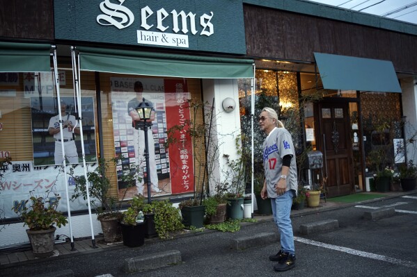 Hironobu Kanno, representative of a private fan club of Shohei Ohtani of the Los Angeles Dodgers, speaks at his beauty salon in Oshu, northeastern Japan, the hometown of Ohtani, Tuesday, Oct. 29, 2024. (AP Photo/Eugene Hoshiko)
