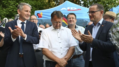 AfD members Björn Hock, left, Robert Sesslemann, center, Stephan Brandner, third from left, and Tino Kruppalla, are photographed at the AfD election party in Sonneberg, Germany, Sunday, June 25, 2023.  Sesselman has received the most votes.  First round of run off election.  The Alternative for Germany political party hopes to win the first governing post.  (Martin Schutt/dpa via AP)