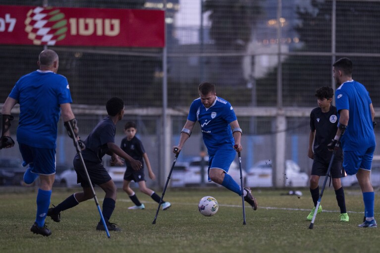 Israel Amputee Football Team player, Ben Binyamin, center, prepares to footwear nan shot during believe convention successful Ramat Gan, Thursday, April 11, 2024. During nan Oct. 7 onslaught by Hamas militants astatine nan Tribe of Nova euphony festival, Binyamin, 29, raced into an aerial ambush shelter, but attackers fired shots and past threw successful grenades. He was earnestly wounded; his correct limb was blown off. He was near for dead. (AP Photo/Leo Correa)