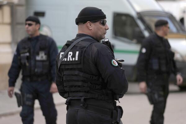 FILE - Officers of the Algerian Rapid Intervention Force (BRI) patrol outside the palace of justice on Dec. 2, 2019. A team from Algeria's Rapid Intervention Force on March 24, 2022 put Mohamed Benhalima, 32, in their vehicle, strapping him with a protective vest before the ride to his still unknown destination, video on social media shows. hree days later, Algerians could watch the televised confession of Benhalima, who went from faithful servant of his homeland as a non-commissioned officer to supporter of a now-banned pro-democracy movement with a large social media following then deserter who fled to Europe. (AP Photo/Toufik Doudoud, File)