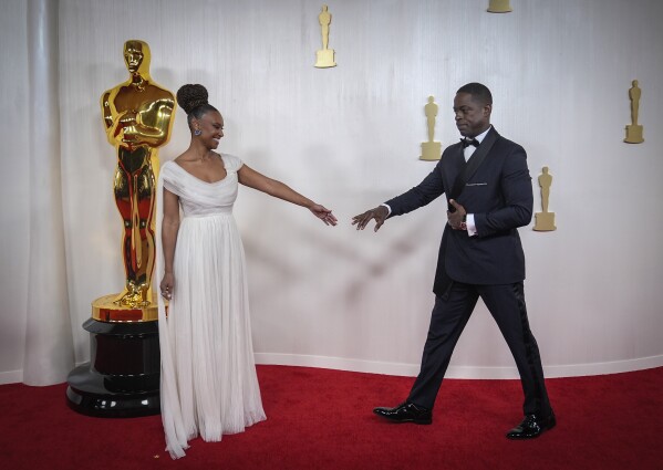 Ryan Michelle Bathe (L) and Sterling K. Brown arrive at the Oscars on Sunday, March 10, 2024, at the Dolby Theatre in Los Angeles. (AP Photo/Ashley Landis)