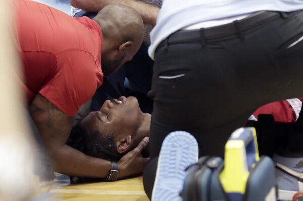 North Carolina State player Terquavion Smith, bottom, is tended by medical personnel after he crashed to the floor after being fouled during the second half of an NCAA college basketball game against North Carolina, Saturday, Jan. 21, 2023, in Chapel Hill, N.C. (AP Photo/Chris Seward)