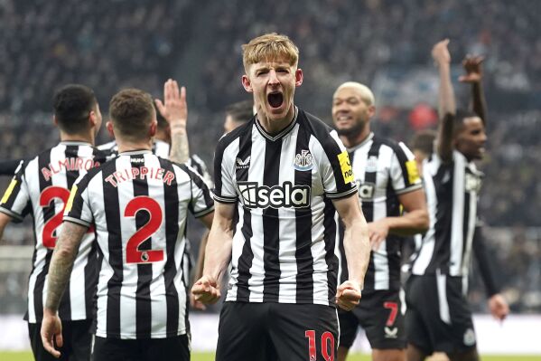 Newcastle United's Anthony Gordon, center, celebrates scoring a goal during the English Premier League soccer match between Newcastle United and Manchester United at St. James' Park, Newcastle, England, Saturday, Dec. 2, 2023. (Owen Humphreys/PA via AP)