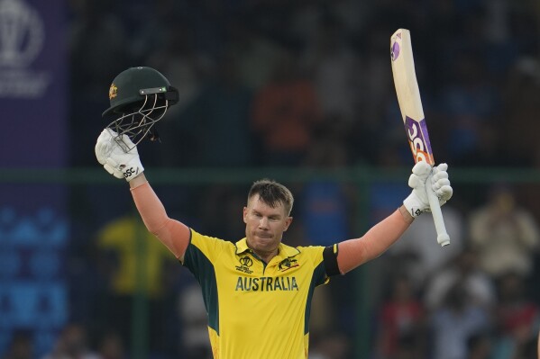 Australia's David Warner celebrate scoring a century during the ICC Men's Cricket World Cup match between Australia and Netherlands in New Delhi, India, Wednesday, Oct. 25, 2023. (AP Photo/Manish Swarup)