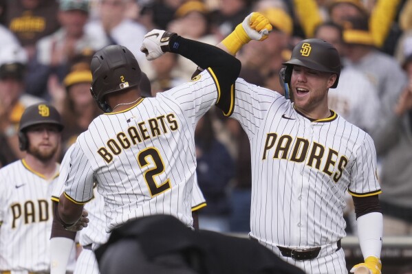 San Diego Padres' Xander Bogaerts (2) celebrates with teammates after hitting a three-run home run during the first inning of a baseball game against the Los Angeles Angels Wednesday, May 14, 2025, in San Diego. (AP Photo/Gregory Bull)