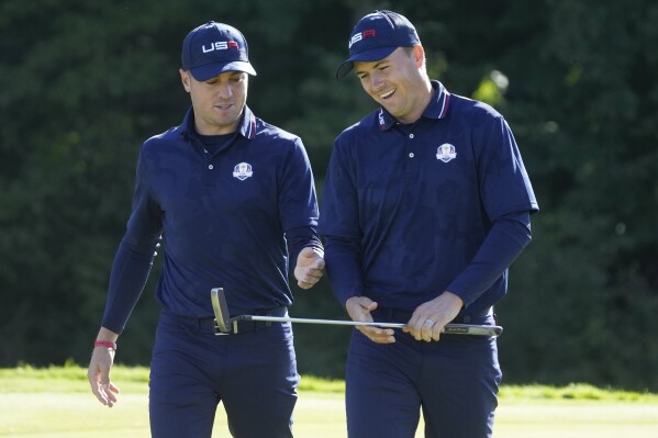 FILE - Team USA's Justin Thomas and Jordan Spieth react as they walk off the ninth green during a foursomes match at the Ryder Cup at the Whistling Straits Golf Course Saturday, Sept. 25, 2021, in Sheboygan, Wis. Thomas and Spieth were among six wild-card selections for the 2023 U.S. Ryder Cup team on Tuesday, Aug. 29, 2023. (AP Photo/Charlie Neibergall, File)