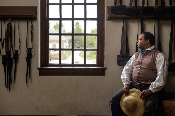 In this Sept 19, 2017 photo, Stephen Seals portrays James Armistead Lafayette at Colonial Williamsburg, an immersive living-history museum in Williamsburg, Virginia, where costumed interpreters of history reenact scenes and portray figures from that period.  (Darnell Vennie/Colonial Williamsburg via AP)