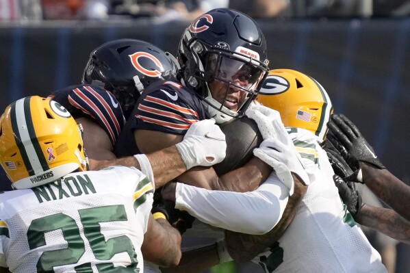 Chicago Bears wide receiver DJ Moore carries the ball in traffic during the first half of an NFL football game against the Green Bay Packers Sunday, Sept. 10, 2023, in Chicago. (AP Photo/Nam Y. Huh)