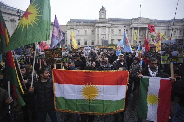People take part in a Kurdish community march in response to the arrest of seven people said to be associated with the Kurdistan Workers Party, known as the PKK, in London, Sunday, Dec, 1, 2024. (James Manning/PA via AP)