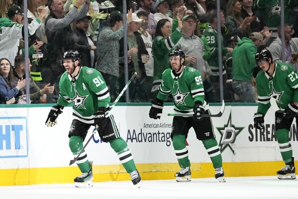 Dallas Stars' Tyler Seguin (91), Matt Duchene (95) and Mason Marchment (27) skate to the bench after Seguin scored against the Arizona Coyotes during the seond period of an NHL hockey game Wednesday, March 20, 2024, in Dallas. (AP Photo/Tony Gutierrez)