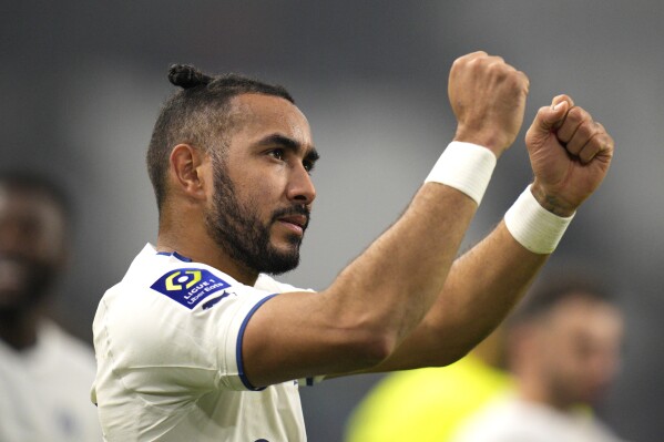 FILE - Marseille's Dimitri Payet celebrates his team's victory in the French League One soccer match against Lyon, at the Velodrome stadium in Marseille, southern France, Nov. 6, 2022. The 36-year-old midfielder, who arrived in Rio de Janeiro, Wednesday, Aug. 16, 2023, is expected to sign a deal with the Brazilian club Vasco da Gama. (AP Photo/Daniel Cole, File)