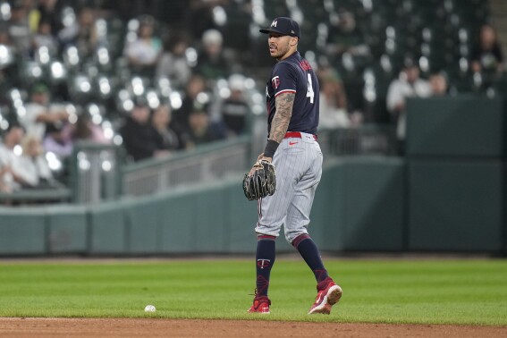Minnesota Twins shortstop Carlos Correa drops a ground ball from Chicago White Sox's Elvis Andrus during the fourth inning of a baseball game Saturday, Sept. 16, 2023, in Chicago. (AP Photo/Erin Hooley)
