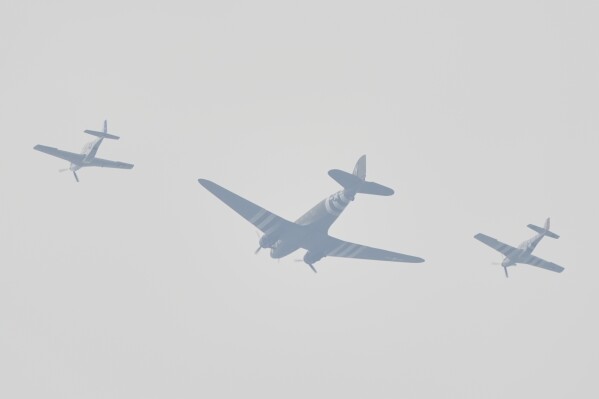 A Douglas C-47 Skytrain, center, flanked by two P41 Fighters perform a flyover during a parade honor the Army's 250th anniversary, coinciding with President Donald Trump's 79th birthday, Saturday, June 14, 2025, in Washington. (AP Photo/J. Scott Applewhite)