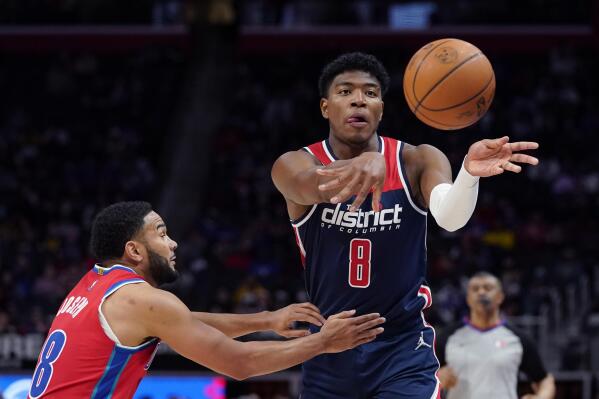 Washington Wizards forward Rui Hachimura (8) passes as Detroit Pistons guard Cory Joseph defends during the second half of an NBA basketball game, Friday, March 25, 2022, in Detroit. (AP Photo/Carlos Osorio)