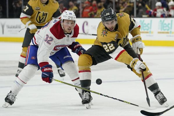 Montreal Canadiens center Rem Pitlick (32) battles for the puck with Vegas Golden Knights center Michael Amadio (22) during the second period of an NHL hockey game Thursday, Jan. 20, 2022, in Las Vegas. (AP Photo/John Locher)