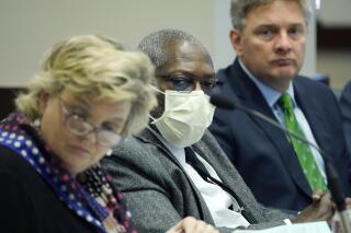 Sens. Nicole Boyd, R-Oxford, left, John Horhn, D-Jackson, center, and Joey Fillingane, R-Sumrall, listen to an agency head discuss their financial budget needs during a meeting of the Joint Legislative Budget Committee in Jackson, Miss., Friday, Sept. 24, 2021. (AP Photo/Rogelio V. Solis)