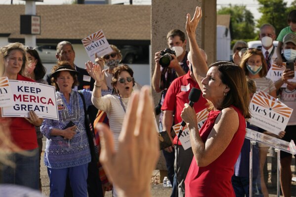 Arizona Republican Sen. Martha McSally sings "God Bless America" as she campaigns at Arizona Republican Party Headquarters Monday, Nov. 2, 2020, in Phoenix. McSally is running against Democratic candidate Mark Kelly in the election set for tomorrow. (AP Photo/Ross D. Franklin)