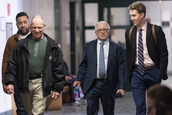 Eagles manager Irving Azoff, center, arrives at supreme court to testify, Thursday, Feb. 22, 2024, in New York. A judge in New York will continue hearing testimony today in a criminal case involving ownership of the handwritten lyrics for the songs on the "Hotel California" album by The Eagles. (AP Photo/Mary Altaffer)
