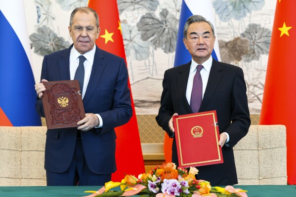 In this photo released by Russian Foreign Ministry Press Service on Tuesday, April 9, 2024, Russian Foreign Minister Sergey Lavrov, left, and Chinese Foreign Minister Wang Yi attend a signing ceremony following their talks in Beijing, China. Russian Foreign Minister Sergey Lavrov is visiting Beijing to display the strength of ties with close diplomatic partner China amid Moscow's grinding war against Ukraine. (Russian Foreign Ministry Press Service via AP)