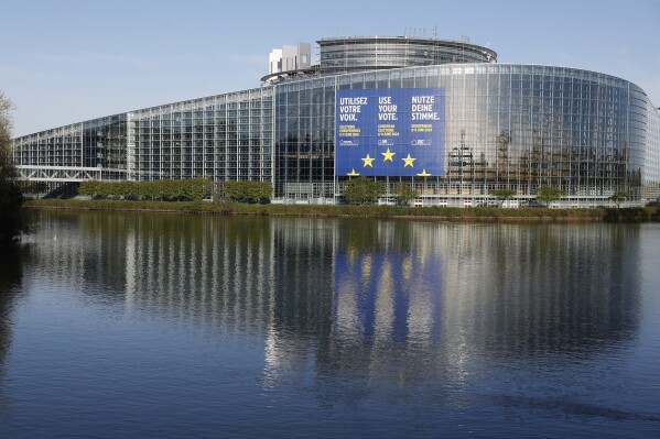 FILE - A giant canvas promoting the European elections is seen on the European Parliament on April 11, 2024 in Strasbourg, eastern France. The European Elections will take place from June 6 to June 9 2024. In the June 6-9 polls, teens as young as 16 will be allowed to vote in some of the 27 member states. (AP Photo/Jean-Francois Badias, File)